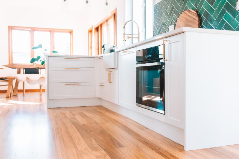 white kitchen cabinets with brown handles